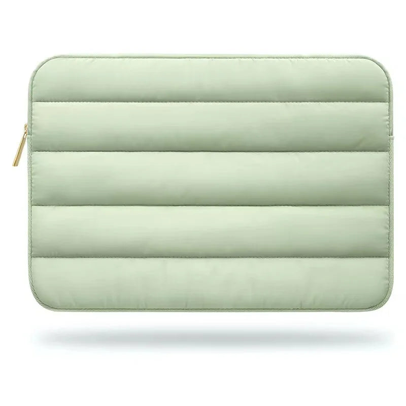 Light green quilted pouch with a zipper on a white background