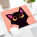 Mouse pad with a black cat design on a desk