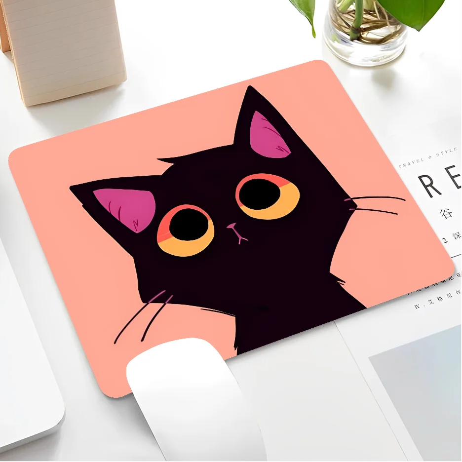 Mouse pad with a black cat design on a desk