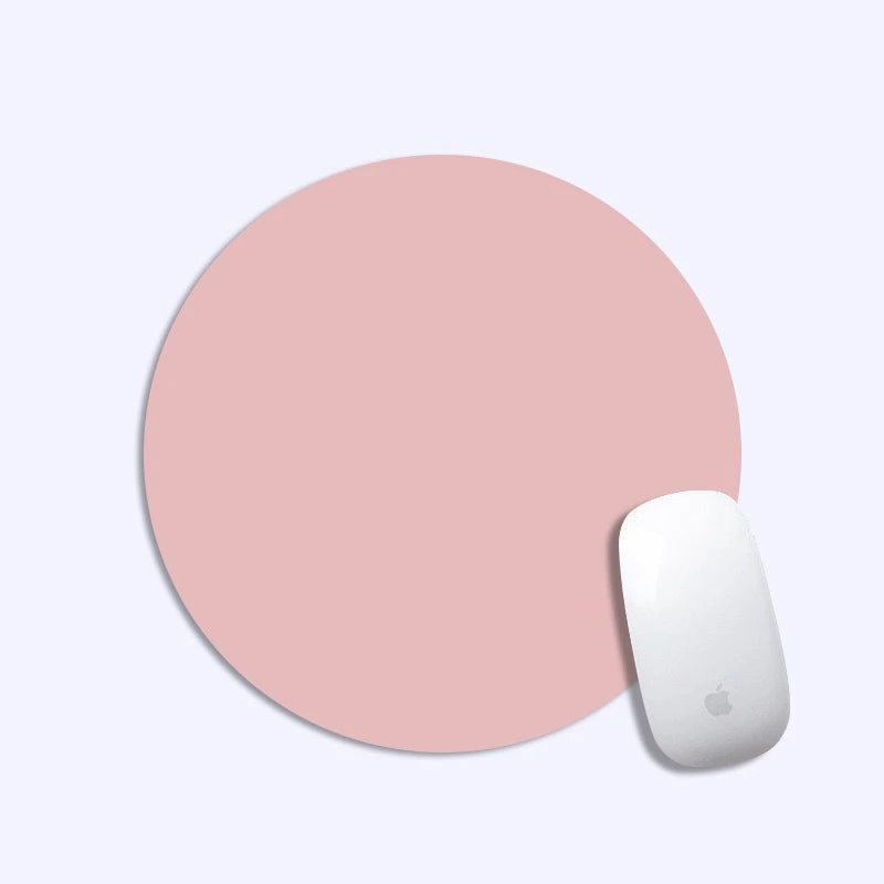 Pink round mouse pad with a white mouse on a light gray background